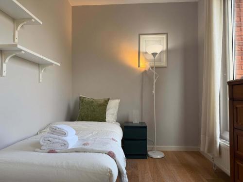 a bedroom with a bed with towels on it at Spacious Family Home and Free Parking in Eindhoven in Eindhoven