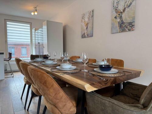 a dining room table with chairs and wine glasses at Spacious Family Home and Free Parking in Eindhoven in Eindhoven