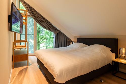 Postel nebo postele na pokoji v ubytování Natuur Villa met Hottub | 4 personen - Resort Valley