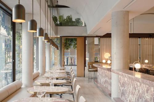 a row of tables in a restaurant with windows at Mid-Century Luxe - Story Bridge & River Views in Brisbane