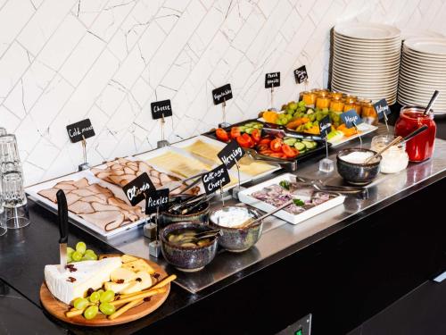 a buffet with appetizers and food on a table at TRIBE Riga City Centre in Rīga