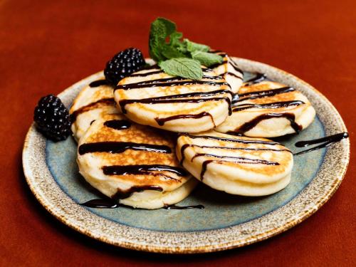 a plate of cookies with chocolate and mint on a table at TRIBE Riga City Centre in Rīga