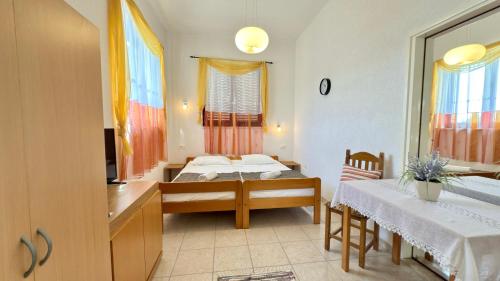 a bedroom with two beds and a table and a mirror at VILLAMAR beachfront apartments with FREE private parking in Rabac