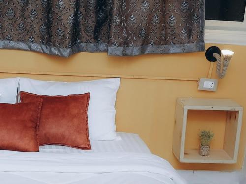 a bedroom with a white bed with a window at Pajama Hostel Nile View in Aswan