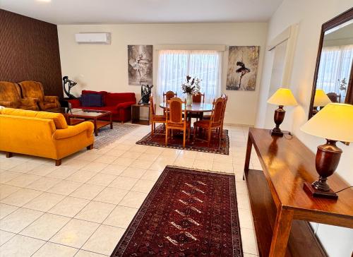a living room with a couch and a table at Family House in Limassol