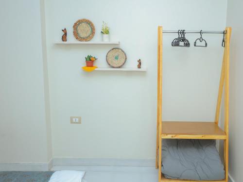 a room with a shelf and a mirror at Pajama Hostel Nile View in Aswan