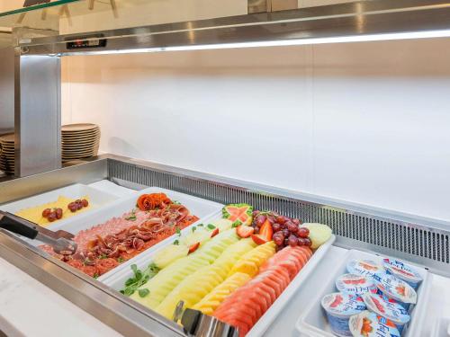 a display case with a bunch of different types of food at Mercure Newport in Newport