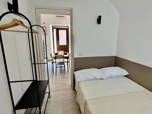 a bedroom with a bunk bed and a table at Casa Lucid'amare Relaxation in Isola delle Femmine