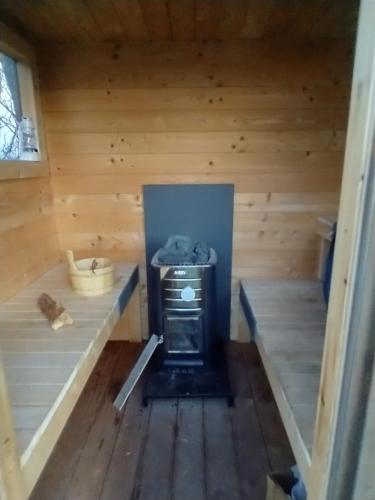 an inside view of a sauna with a stove at Apartment with water views in Fjerritslev