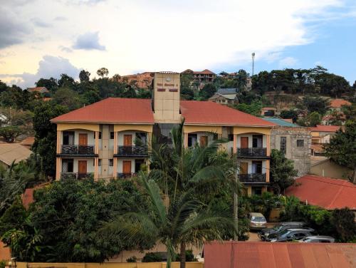 a building with a tower on top of a city at Palm Gardens Guesthouse in Kampala