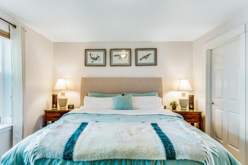 a bedroom with a large bed with two night stands at Ocean Breeze in Westport