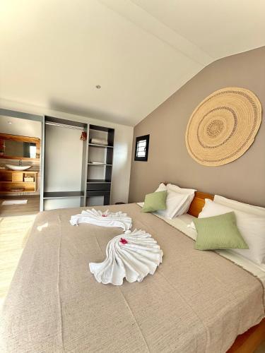 a large bed with two white towels on it at Villa Solaya - Sud Sauvage in Saint-Joseph