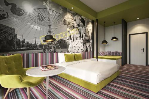 a bedroom with a bed and a table and chairs at Mamaison Vibe Hotel Downtown Budapest in Budapest