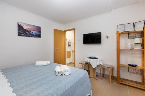 Un dormitorio con una cama con dos toallas blancas encima. en Apartment Kreslin, en Vantačići