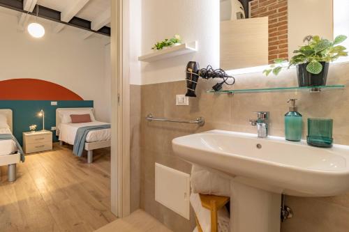 a bathroom with a sink and a bedroom at La Montagnola in Castelfranco Veneto