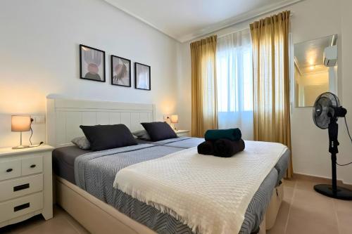 a bedroom with a bed and a fan at Sun golf and swimming pool the ideal villa for your holidays! in Vistabella