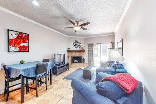 a living room with a blue couch and a table at Camp Warnecke Estates Unit B104 in New Braunfels