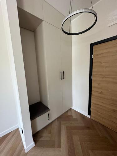 a room with a closet and a door and a staircase at Mieszkanie Apartament stylowy zadbany parking parter in Słupsk