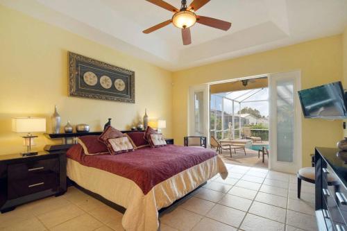 a bedroom with a bed and a ceiling fan at Villa Savona in Cape Coral