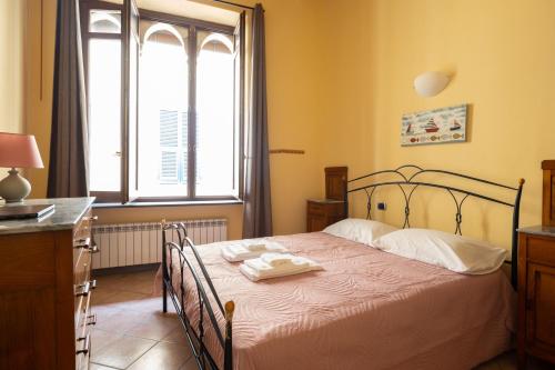 a bedroom with a bed with two towels on it at Levanto Charme apartment up to 6ppl 20 steps to the water in the center in Levanto