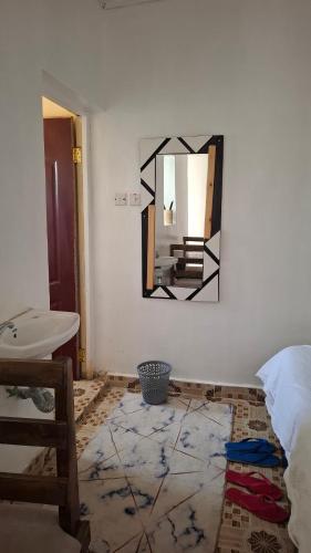 a mirror hanging on a wall in a room at Sinty's furnished homes in Narok