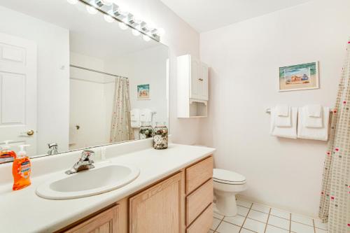 a bathroom with a sink and a toilet at Jewel by the Sea in Westport