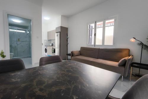 a living room with a table and a couch at Limassol Centr Apartament in Limassol