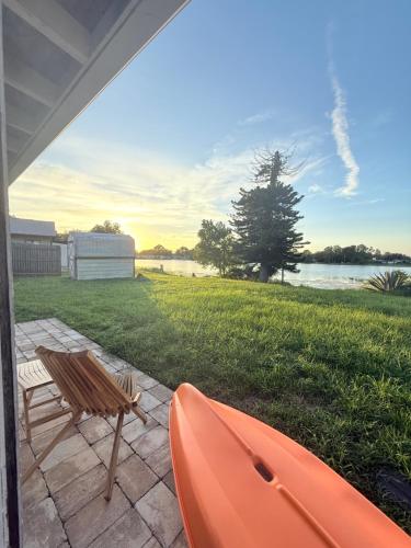 an orange kayak and a bench on a patio at Lake Front Entire Home FL Getaway in Deltona