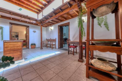 a large living room with a wooden ceiling at La Casucha - Typical Canarian House By Lanzarote Vacation Homes in Tías