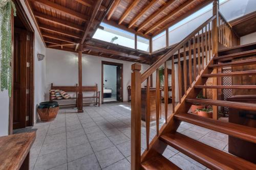 a hallway with wooden stairs and a living room at La Casucha - Typical Canarian House By Lanzarote Vacation Homes in Tías