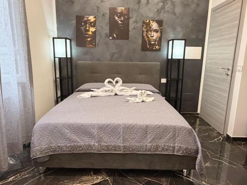 a bedroom with a bed with two towels on it at Belvedere Lacinio Guest House in Crotone