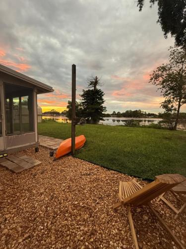 a backyard with an orange infront of a house at Lake Front Entire Home FL Getaway in Deltona