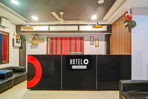a hotel lobby with a hotel sign on the wall at Hotel O Zoo Road Near Guwahati Central in Guwahati