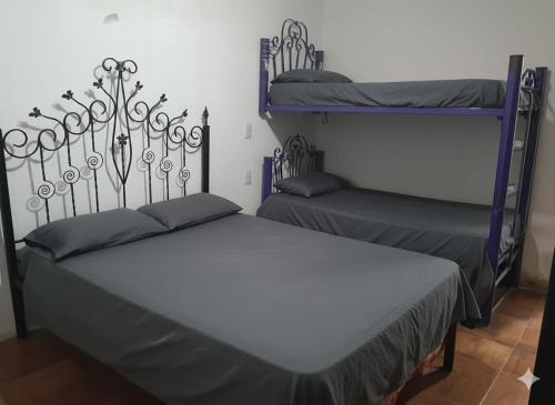 a bedroom with two bunk beds in a room at La Morada de sus Sueños Caeiro in Bialet Massé