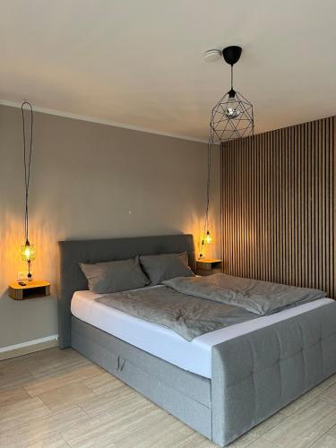 a bedroom with a bed with two lights on it at Cozy apartment in Hagen