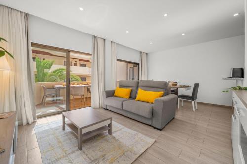 a living room with a couch and a table at Sea View & Shared Pool in Lagos by HostWise in Lagos