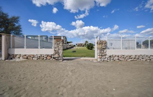 a gate with a stone wall and a fence at Villa Baia Del Circeo in Colonia Elena
