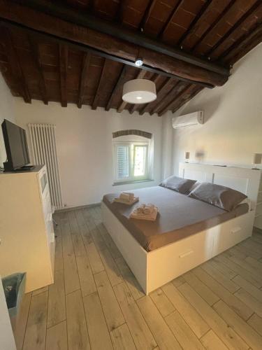 a bedroom with a large bed and a window at Affittacamere Clara in Lucca
