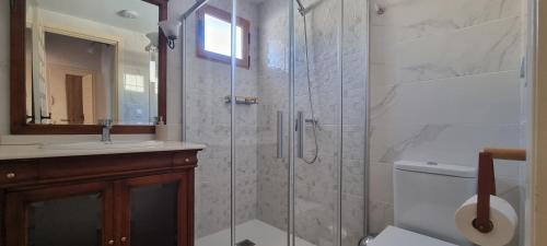 a bathroom with a shower with a toilet and a sink at El Porche de Calabardina Playa - By Aloha Palma in Calabardina