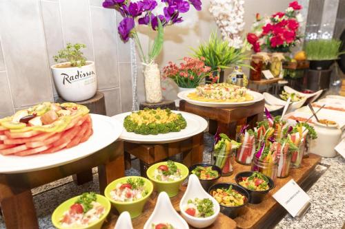 a buffet of food with plates of food at Radisson Hotel Sector 29 Gurugram in Gurgaon