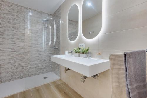 a bathroom with a white sink and a shower at Villa Antonia in Betancuría