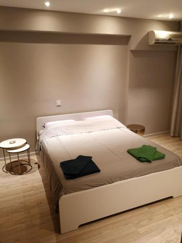 a white bed in a room with a table at Beachfront Amazing New Apartment in Limassol