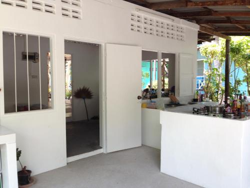 a kitchen with white walls and a counter top at Sea Gate Beach Resort in Thongsala