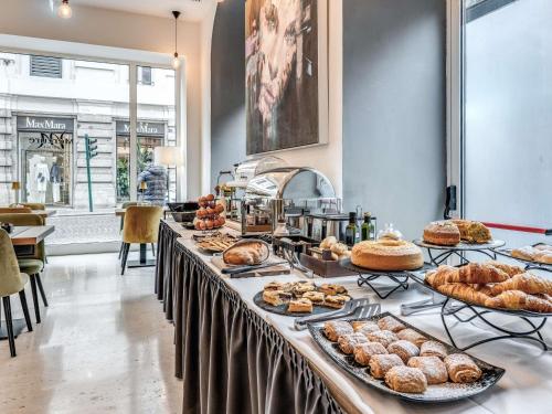 a buffet line with many different types of pastries at Mercure Roma Centro Termini in Rome