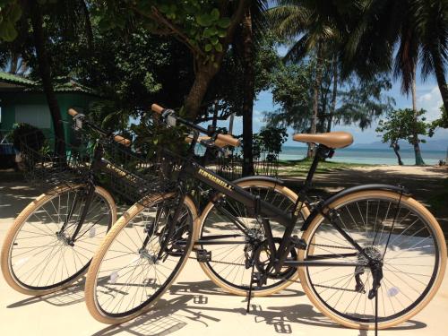 dos bicicletas estacionadas una junto a la otra en la playa en Sea Gate Beach Resort, en Thong Sala