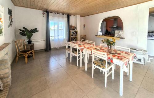 a dining room with a table and chairs at Maison Près De La Mer in LʼAiguillon-sur-Mer
