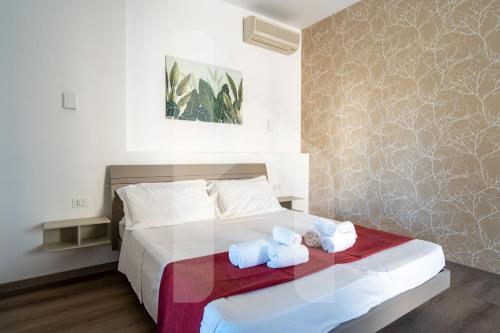 a bedroom with a bed with two towels on it at Homiday - Residence Venere in Alba Adriatica