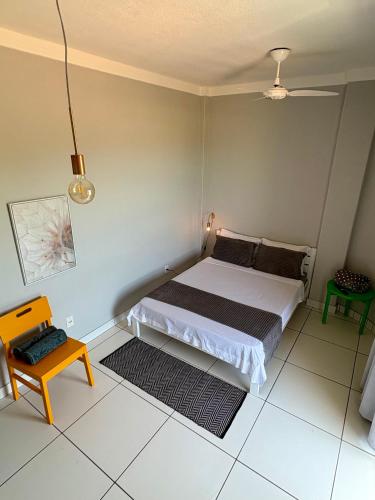 a small bedroom with a bed and a table at Bertholi Beira-Mar in Serra