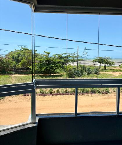 a view of the ocean from a window at Bertholi Beira-Mar in Serra