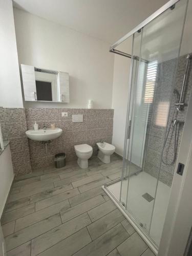 a bathroom with a shower and a toilet and a sink at Affittacamere Clara in Lucca
